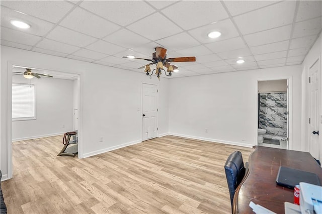 unfurnished office with baseboards, a paneled ceiling, a ceiling fan, light wood-type flooring, and recessed lighting