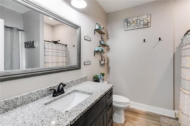 bathroom featuring vanity, curtained shower, wood-type flooring, and toilet