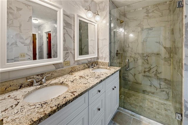 bathroom featuring an enclosed shower and vanity