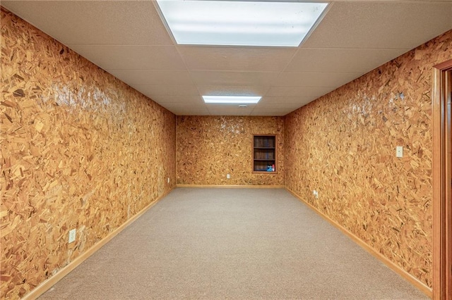 basement featuring carpet and a drop ceiling