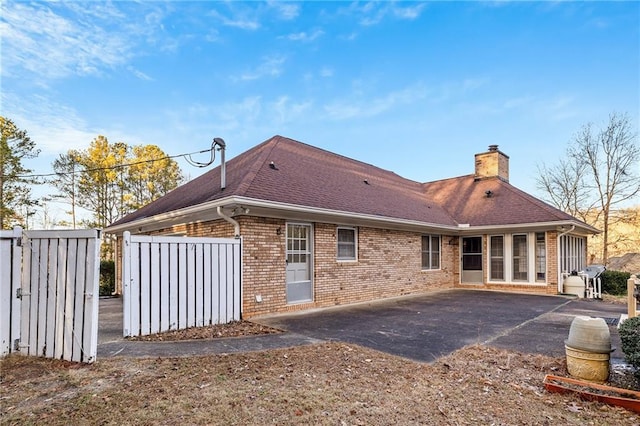 back of property with a patio