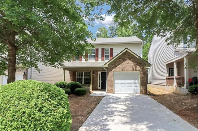 traditional-style home featuring brick siding, concrete driveway, and a garage