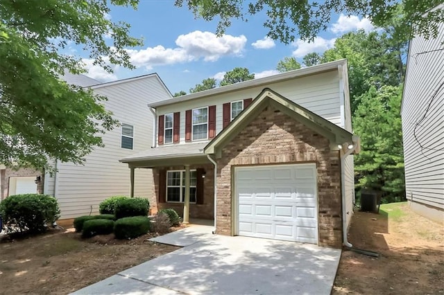 traditional-style house featuring stone siding, an attached garage, and driveway