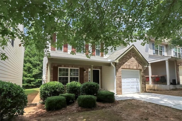 view of front of home with brick siding, concrete driveway, and an attached garage