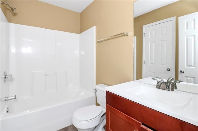 bathroom featuring toilet, vanity, and  shower combination