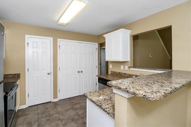 kitchen with light stone countertops, appliances with stainless steel finishes, a peninsula, tile patterned floors, and white cabinets