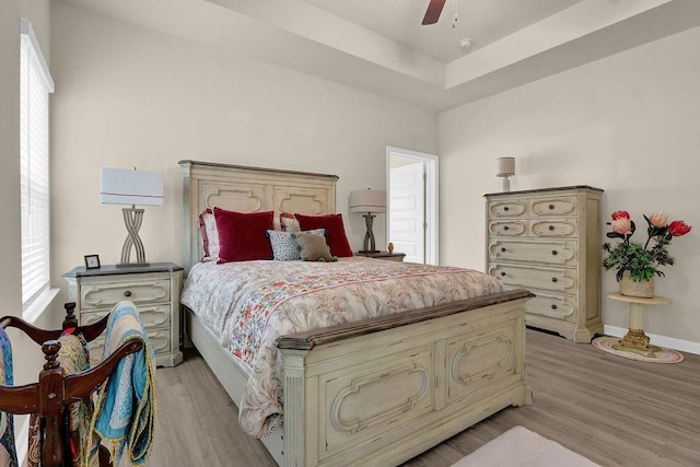 bedroom with multiple windows and light wood-type flooring