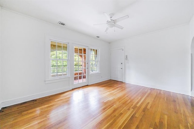 unfurnished room with light wood-style floors, baseboards, and ornamental molding