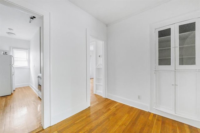 interior space featuring baseboards and light wood-style floors