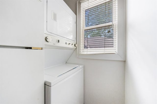 laundry area with laundry area and stacked washer / dryer