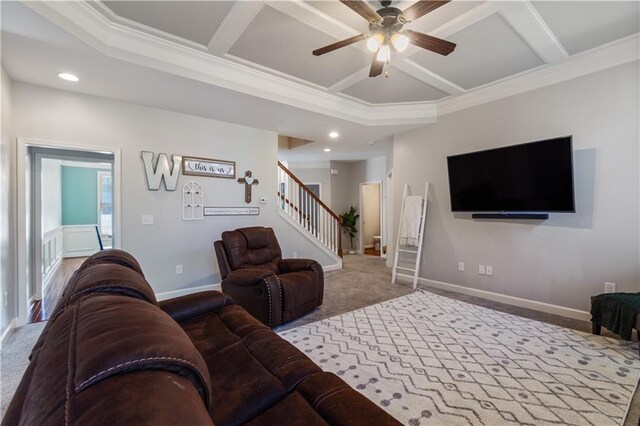 carpeted living room with ceiling fan, crown molding, and coffered ceiling