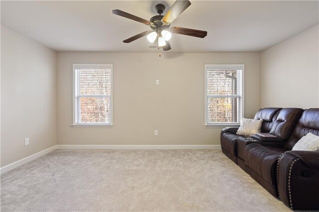 living room with light colored carpet and ceiling fan