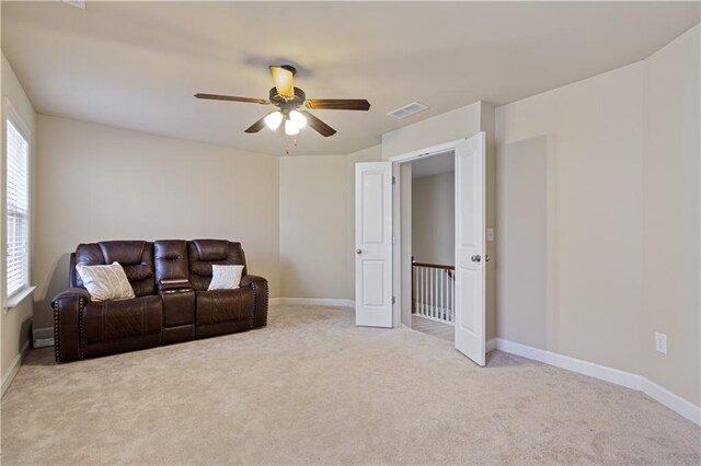 sitting room featuring ceiling fan and light colored carpet