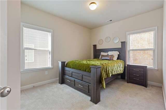 bedroom featuring light carpet