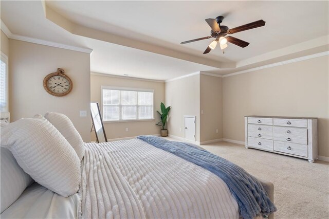 bedroom with a raised ceiling, ceiling fan, crown molding, and light carpet