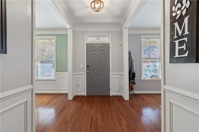 foyer entrance featuring crown molding and wood-type flooring