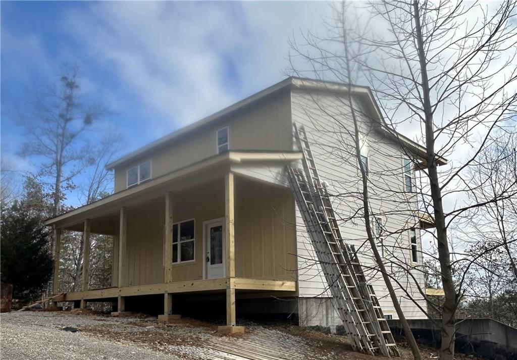 view of side of property featuring covered porch