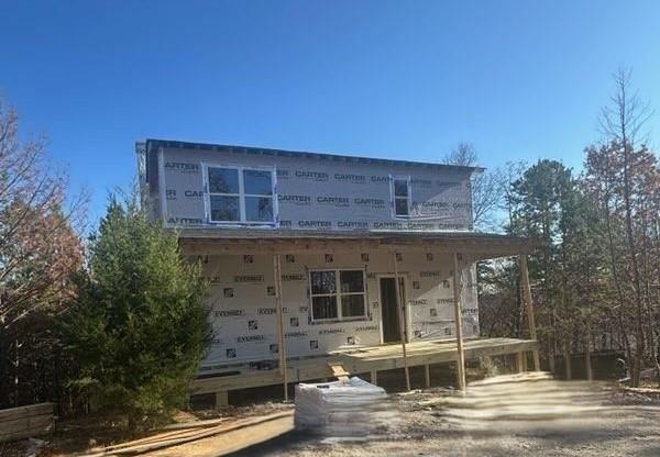 rear view of house with covered porch