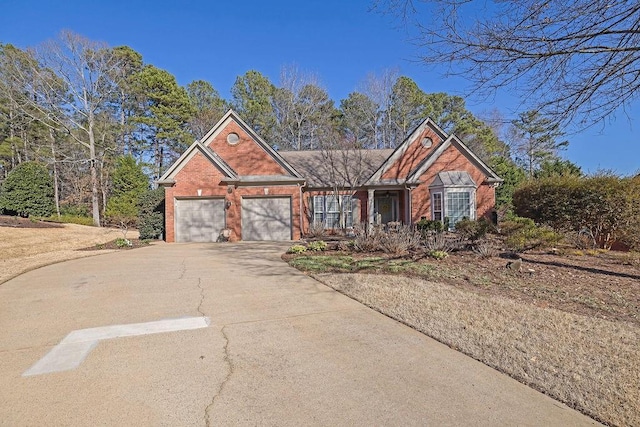 ranch-style house with a garage, concrete driveway, and brick siding