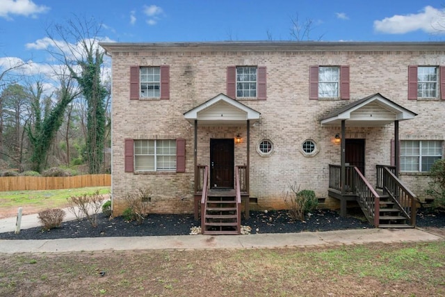 townhome / multi-family property with crawl space, brick siding, and fence