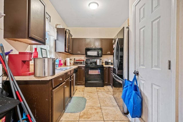 kitchen featuring light tile patterned floors, a toaster, black appliances, light countertops, and dark brown cabinetry