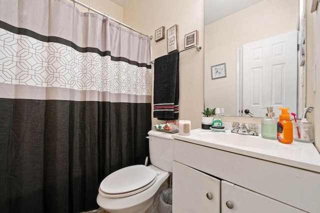 bathroom with a shower with curtain, toilet, and vanity