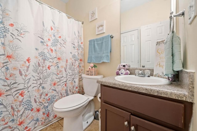 bathroom with a shower with curtain, toilet, vanity, and tile patterned flooring