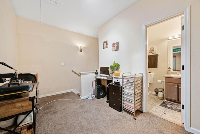 home office featuring light carpet, attic access, and baseboards