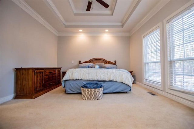 carpeted bedroom featuring a tray ceiling, baseboards, visible vents, and ornamental molding