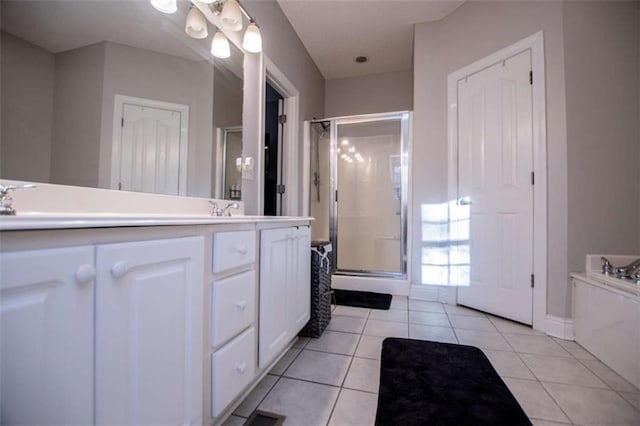 bathroom featuring visible vents, double vanity, a sink, tile patterned flooring, and a shower stall