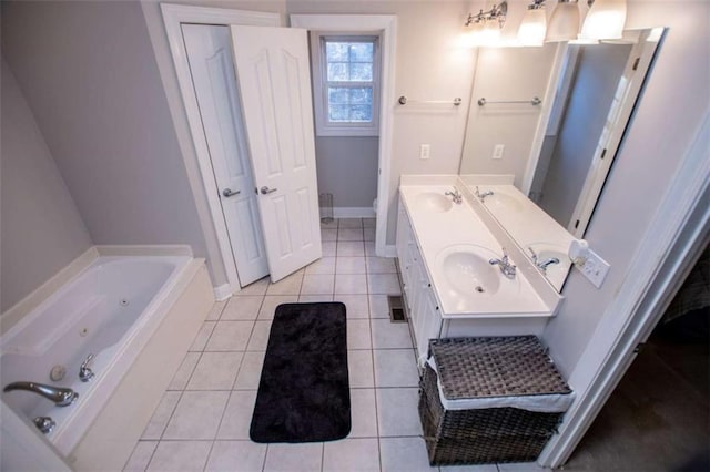 full bath with a sink, tile patterned flooring, double vanity, baseboards, and a whirlpool tub