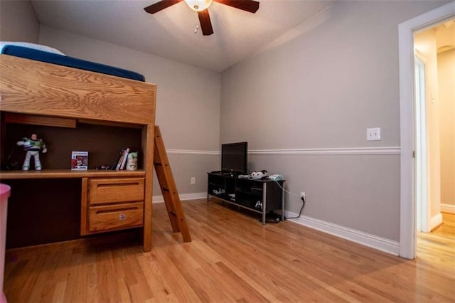 bedroom featuring ceiling fan, baseboards, and light wood-style flooring