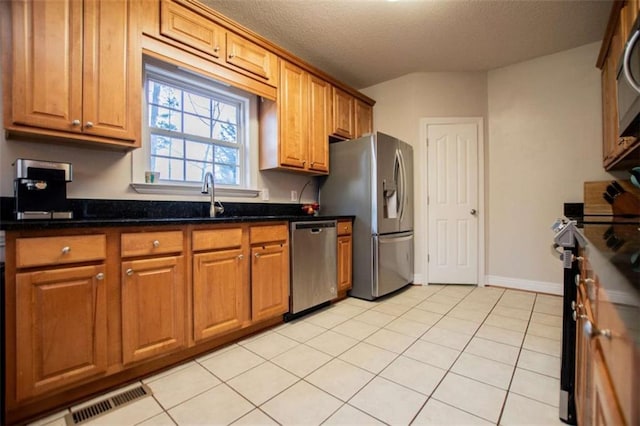 kitchen featuring a sink, visible vents, brown cabinets, and appliances with stainless steel finishes