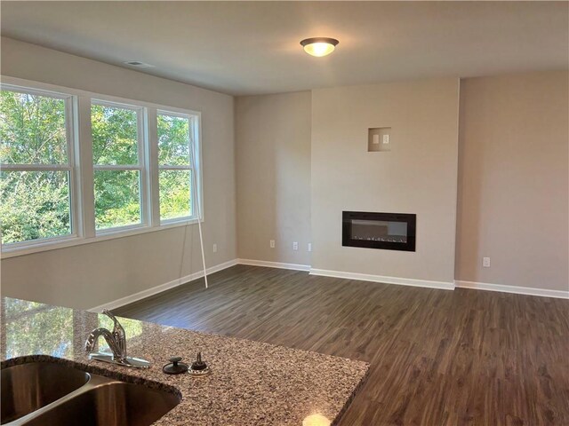 carpeted spare room with a raised ceiling