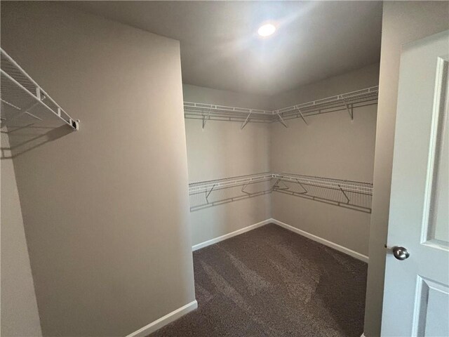 clothes washing area with hookup for a washing machine, dark tile patterned flooring, and electric dryer hookup