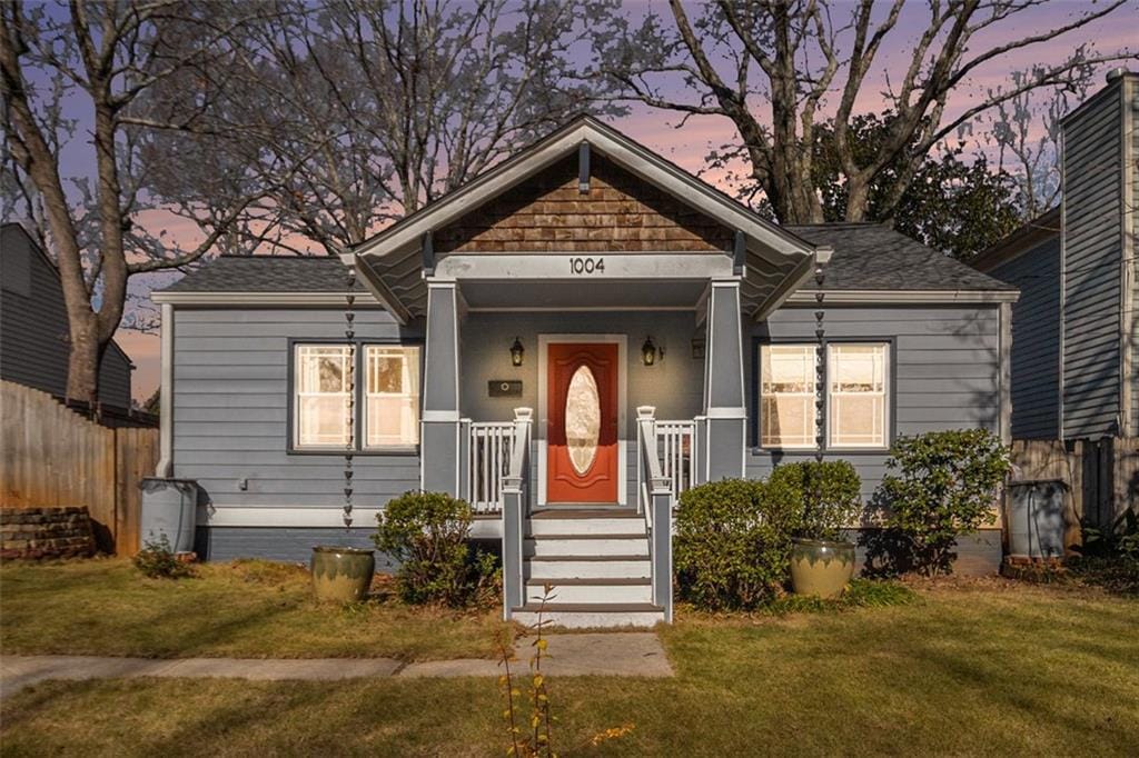 bungalow-style home featuring a lawn