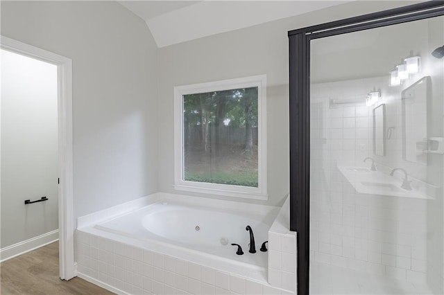 3807 Lance Bluff Ct, Duluth, GA 30097 - bathroom featuring a tub with jets, wood finished floors, a shower stall, and vaulted ceiling
