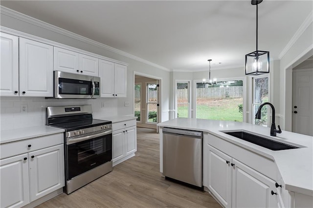 3807 Lance Bluff Ct, Duluth, GA 30097 - kitchen featuring stainless steel appliances, light wood-type flooring, a chandelier, ornamental molding, and white cabinets