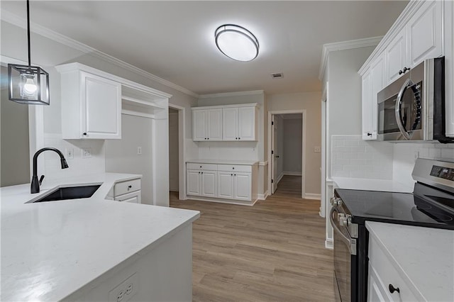 3807 Lance Bluff Ct, Duluth, GA 30097 - kitchen with stainless steel appliances, white cabinets, tasteful backsplash, light wood-type flooring, and ornamental molding