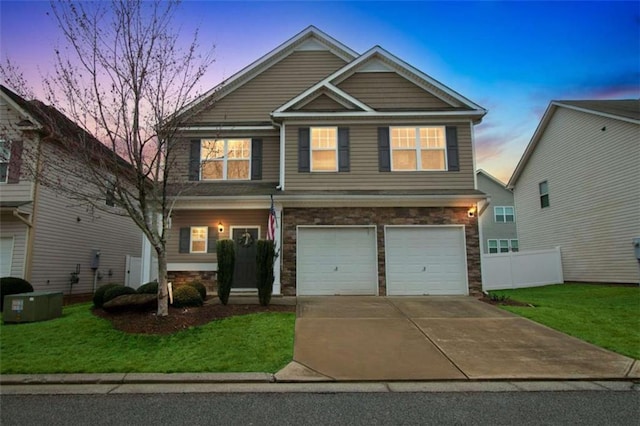 craftsman inspired home with a garage, fence, a front lawn, and concrete driveway