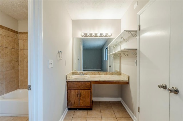 full bath featuring vanity, a textured ceiling, baseboards, and tile patterned floors