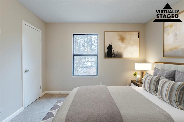 carpeted bedroom with baseboards