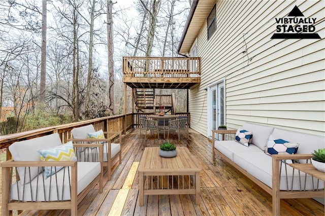 wooden terrace with an outdoor hangout area and outdoor dining space