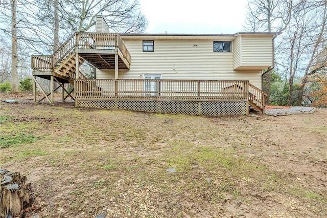 rear view of property featuring stairway and a wooden deck