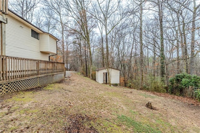 view of yard with a storage unit, a deck, and an outdoor structure