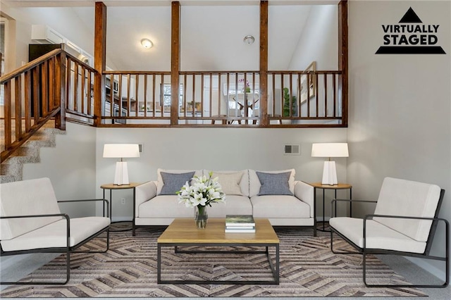 living area with visible vents and stairway