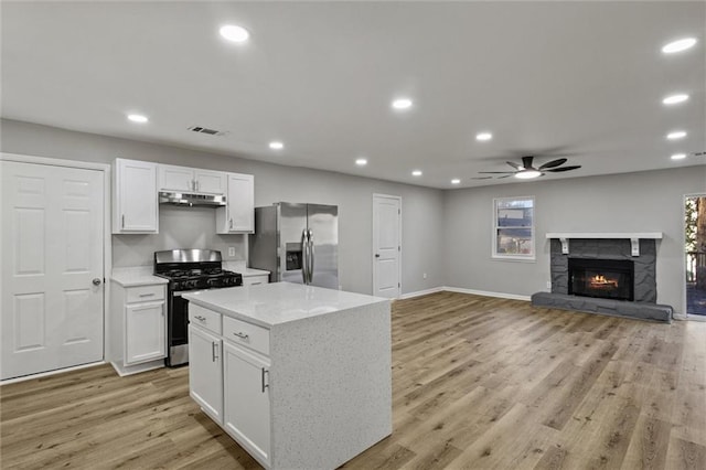 kitchen featuring white cabinetry, visible vents, appliances with stainless steel finishes, and open floor plan