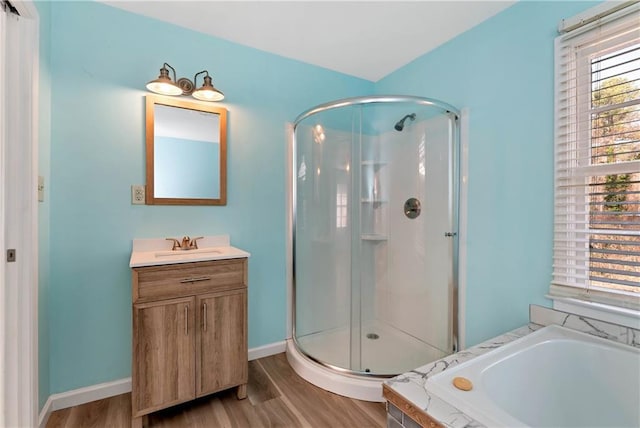 bathroom with hardwood / wood-style floors, vanity, and independent shower and bath