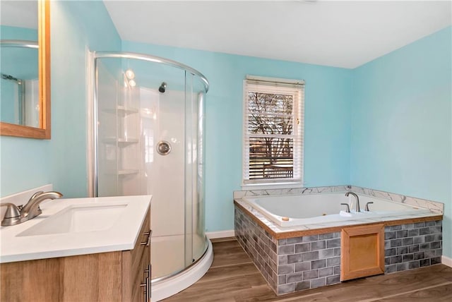 bathroom featuring wood-type flooring, vanity, and shower with separate bathtub