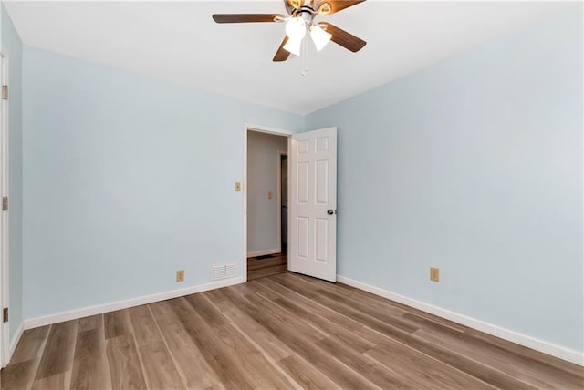 empty room featuring hardwood / wood-style floors and ceiling fan